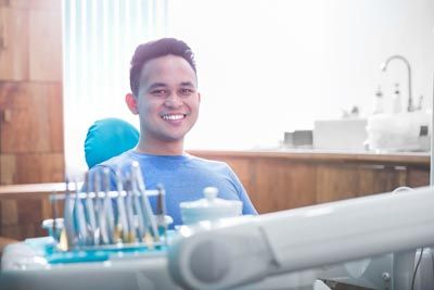 patient smiling during his cosmetic dentistry appointment at Universal Dentistry in Abington, PA