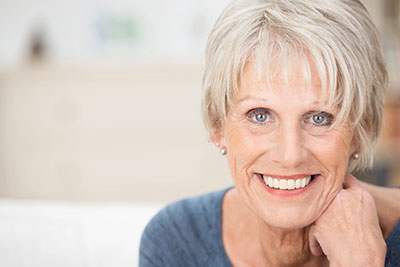 woman smiling with her dental implants from Universal Dentistry in Abington, PA