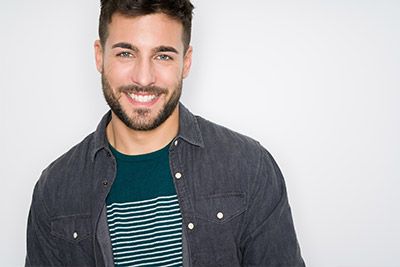 man smiling after getting his teeth whitened at Universal Dentistry in Bensalem, PA