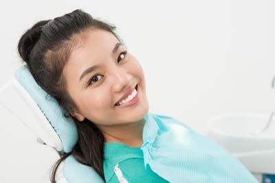 woman smiling during her care at Universal Dentistry in Bensalem, PA