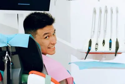 man smiling during his Universal Dentistry appointment to get a dental crown