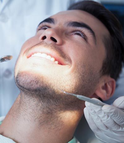 man smiling during his dental care at Universal Dentistry in Cherry Hill, NJ