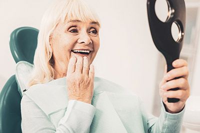 woman loving her dentures from Universal Dentistry in Springfield, PA
