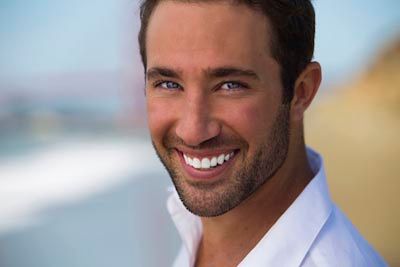 man smiling after his cosmetic dentistry procedure at Universal Dentistry in Turnersville, NJ