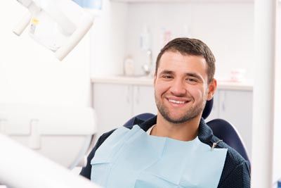 man smiling during his dental appointment at Universal Dentistry Turnersville, NJ