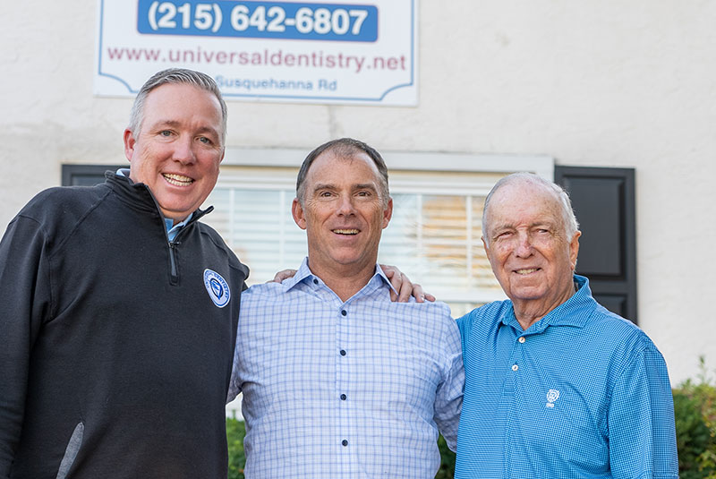 Doctor with two patients standing outside Universal Dentistry