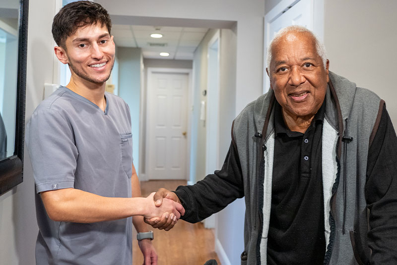 doctor shaking patients hand after dental implant procdure