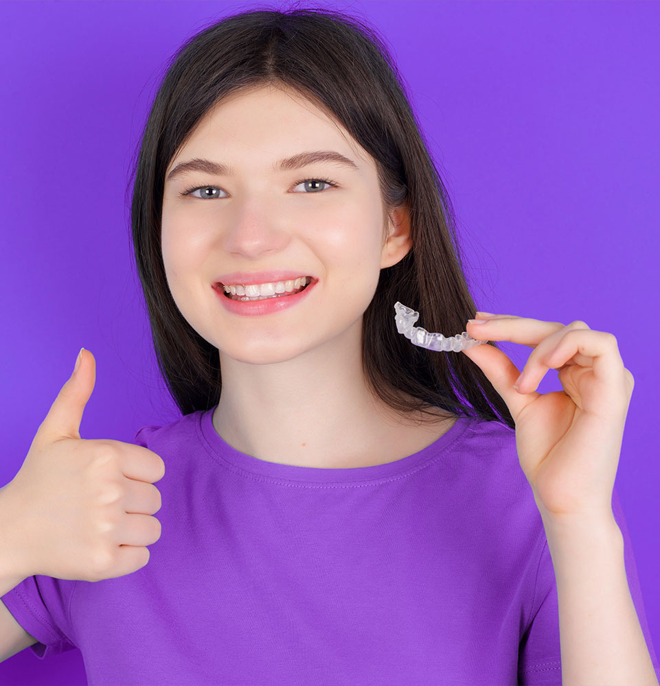 teen holding invisalign