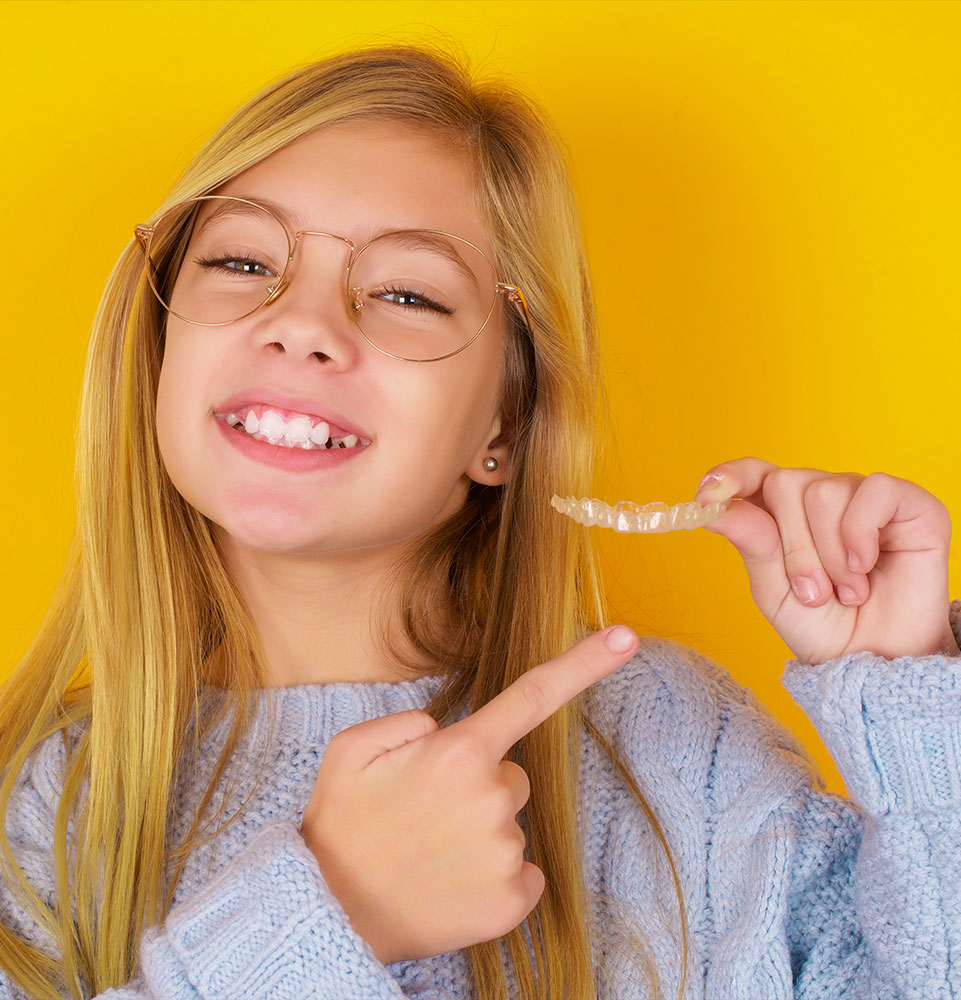 kid holding invisalign