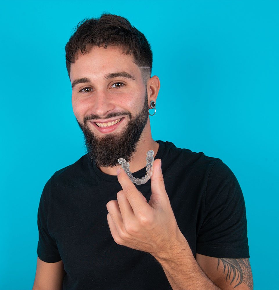 adult holding up invisalign