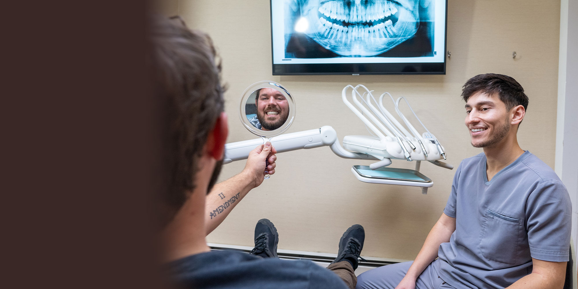 patient smiling with mirror